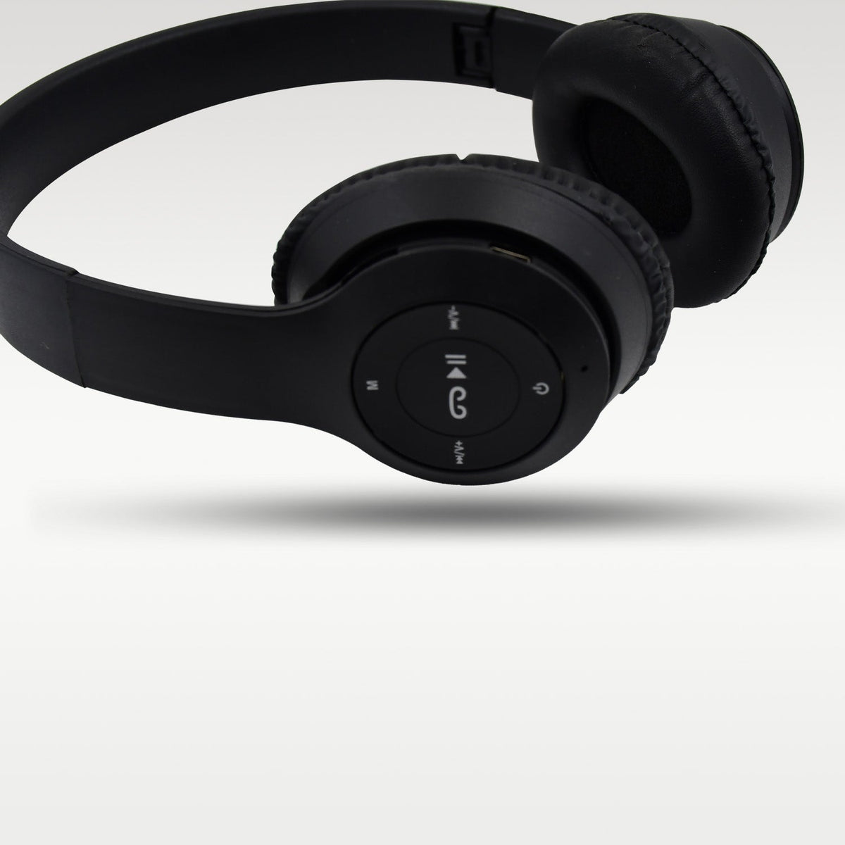 The foldable mechanism of the black wireless headphones for easy storage.