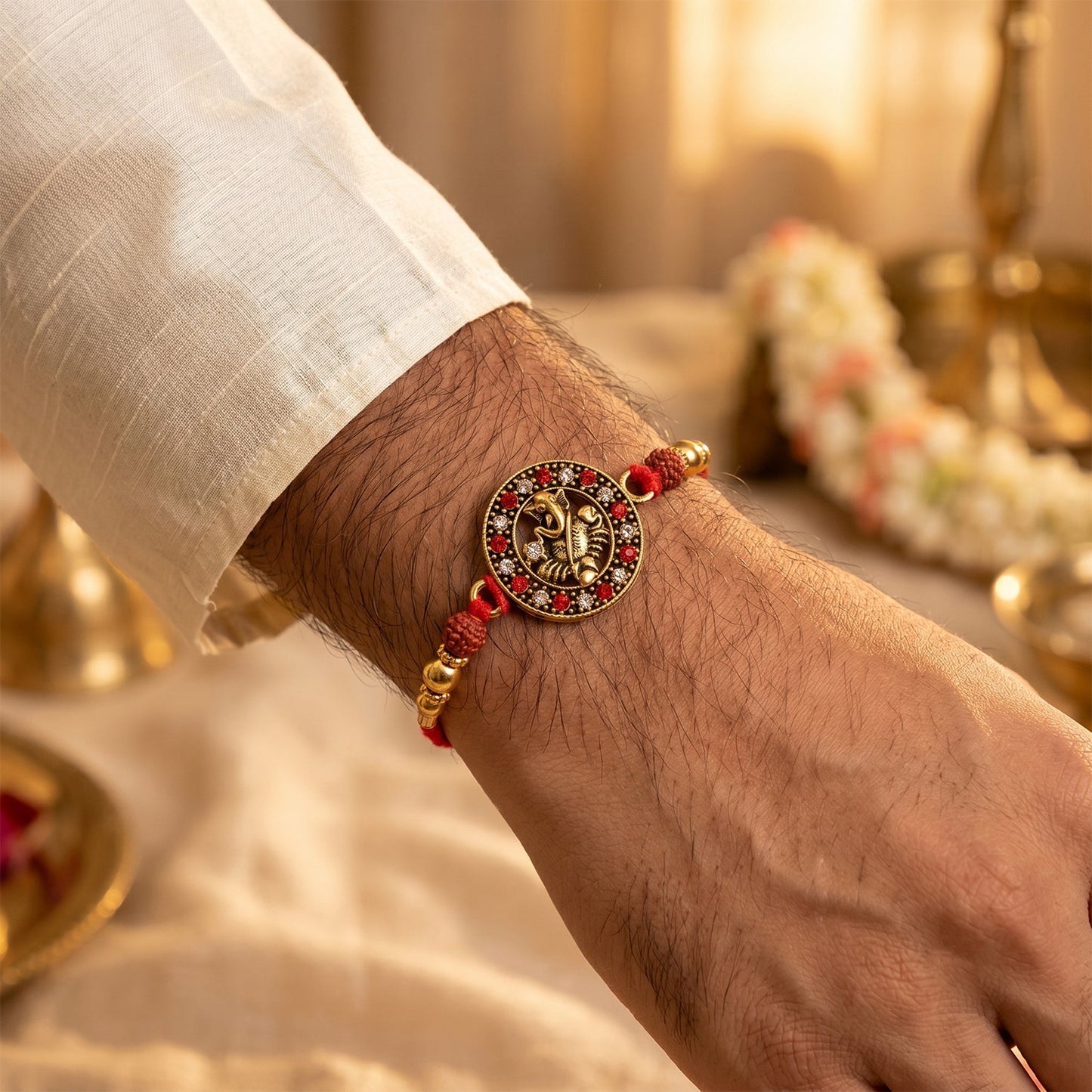 Side view of Golden Ganesh Rakhi showing detailed thread and beads