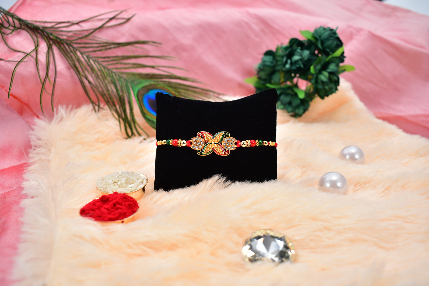 Elegant bead Rakhi with golden flower motif displayed on white background