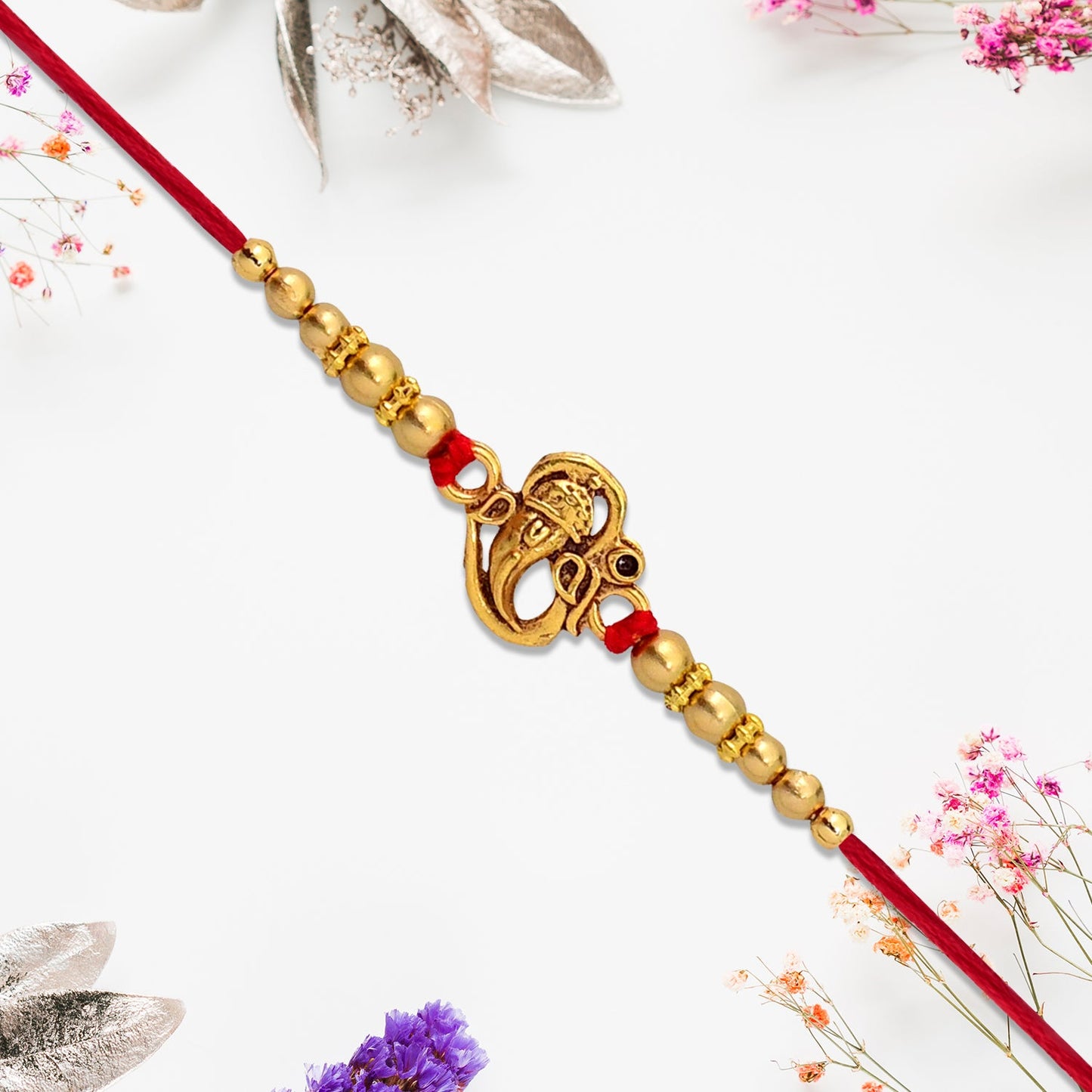 Premium Ganesha Rakhi with detailed idol and sparkling embellishments.