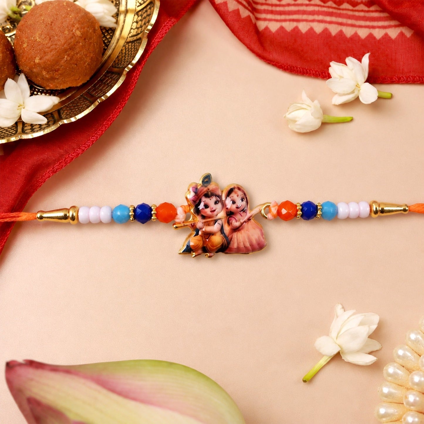 Front view of an elegant Radha Krishna Rakhi with vibrant beads and intricate centerpiece.