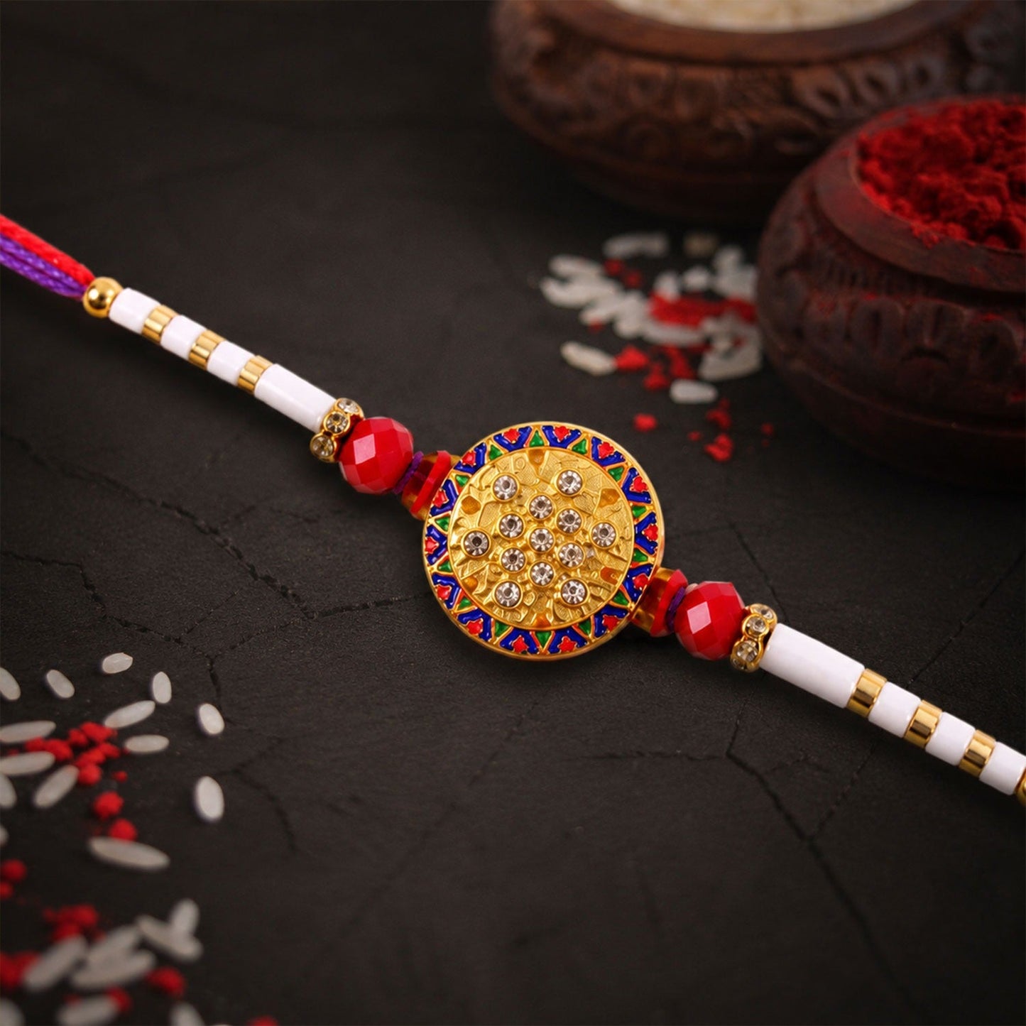 Decorative gold and white bead rakhi with dual-color thread design