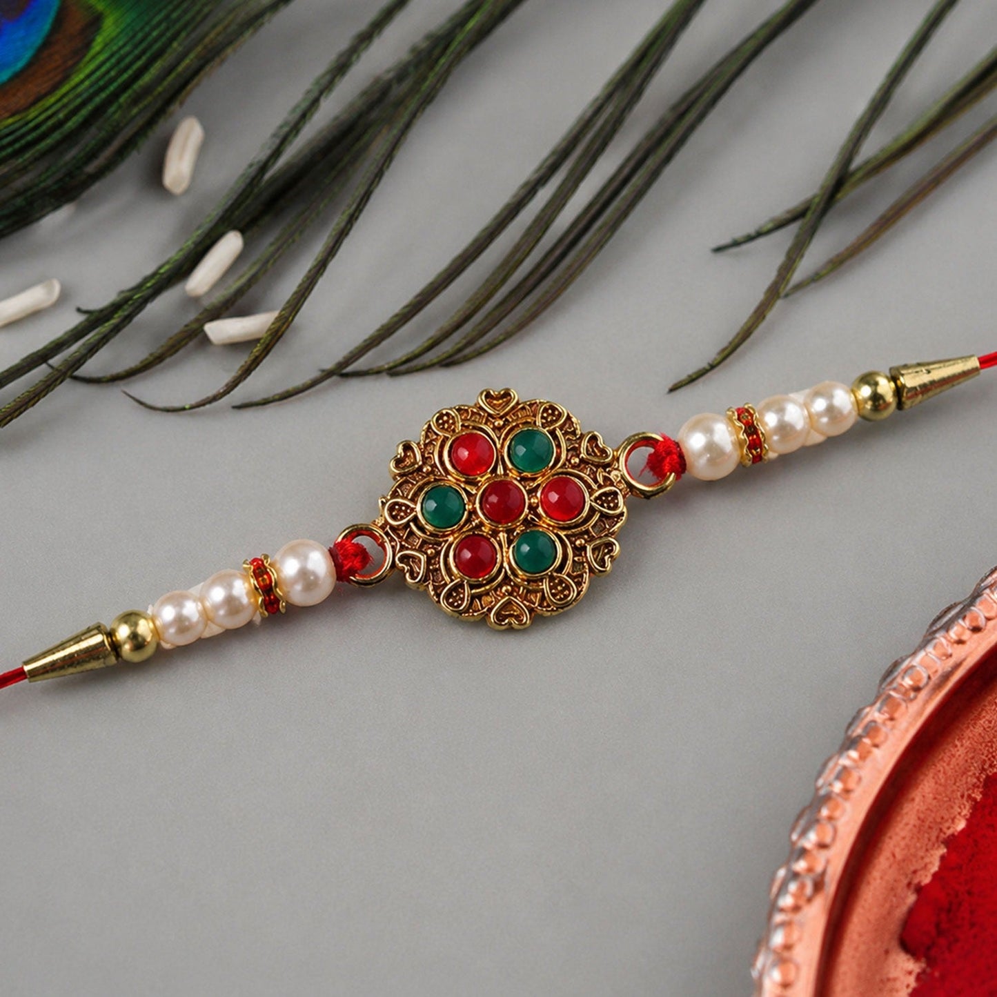 Designer Rakhi with beaded work and floral meenakari centerpiece on festive background
