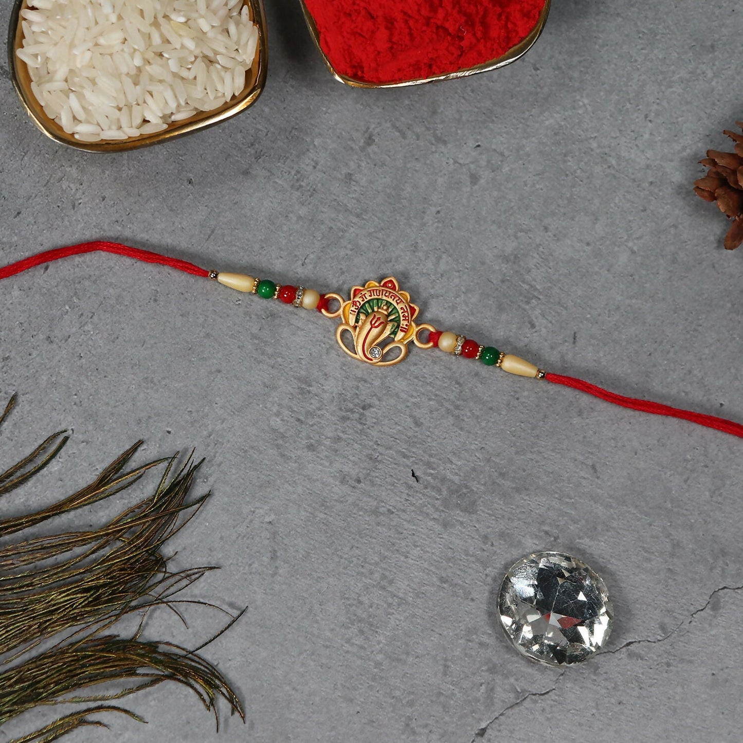 Beautifully handcrafted Om Ganesha Rakhi highlighting sacred motifs.