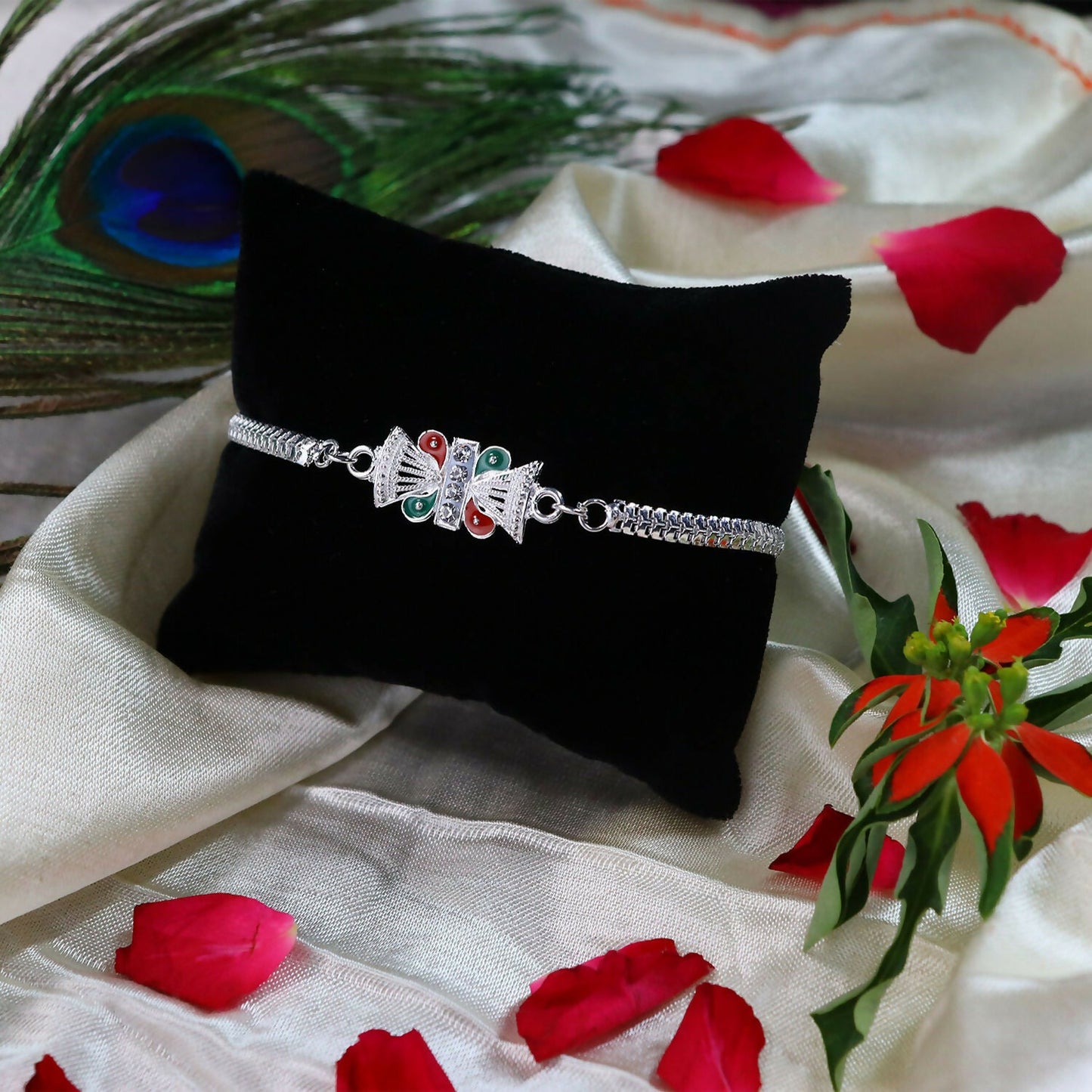 Close-up of silver rakhi with intricate design and festive charm for brother
