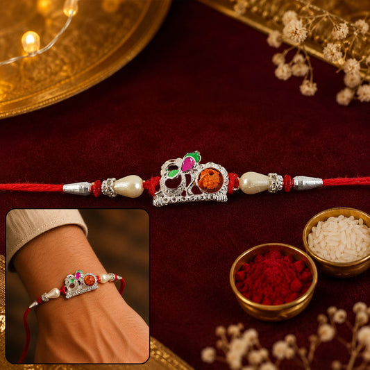 Red Gold Floral Om Rakhi featuring pearls and orange stone center