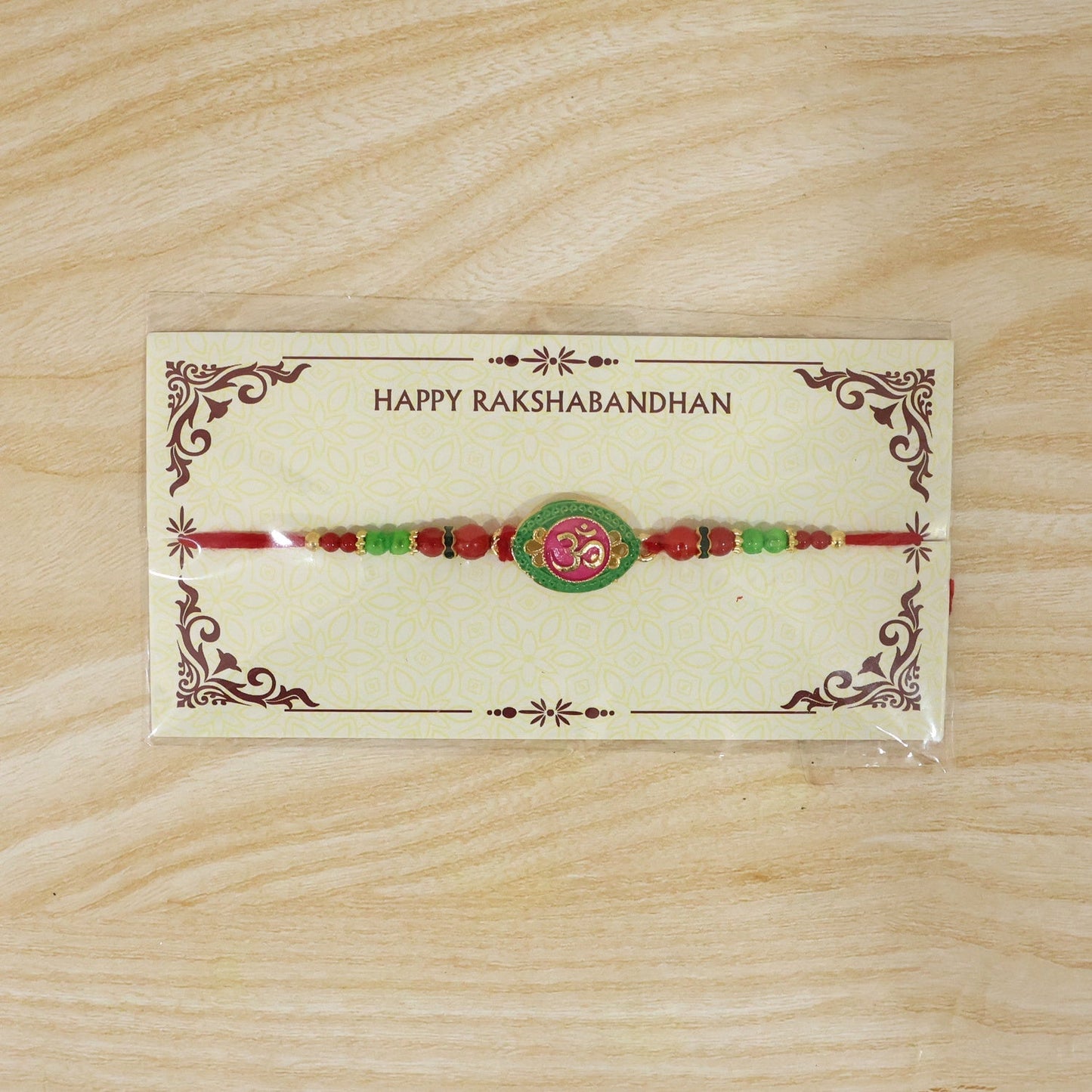 Festive Raksha Bandhan Rakhi featuring pink green OM design