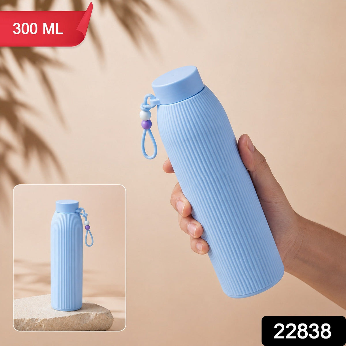 A hand holds a light blue ribbed glass water bottle with a beaded strap, with a smaller inset image showing it on a â€“ view 2