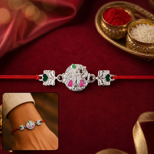 Silver Shrinathji Rakhi with pink & green stones and elephant charms