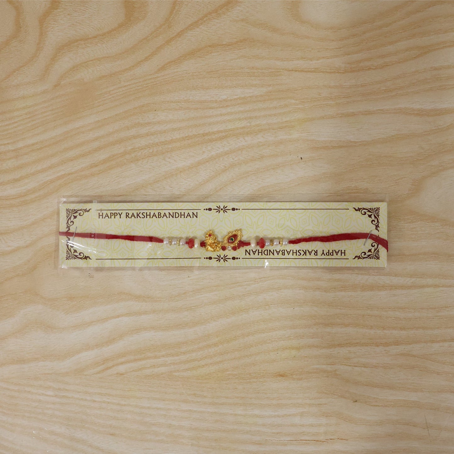 Side perspective of Krishna Mor Pankh Rakhi showing comfortable thread and elegant finish.