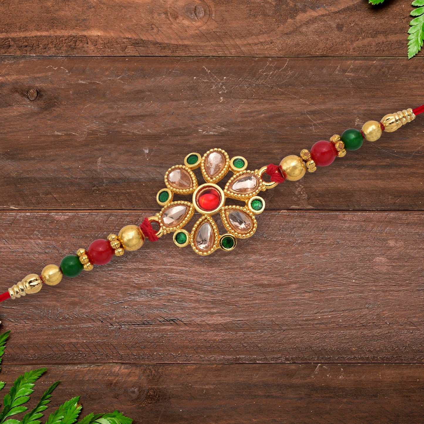 Close-up of the handcrafted Kundan Rakhi detailing the intricate floral design and golden work.