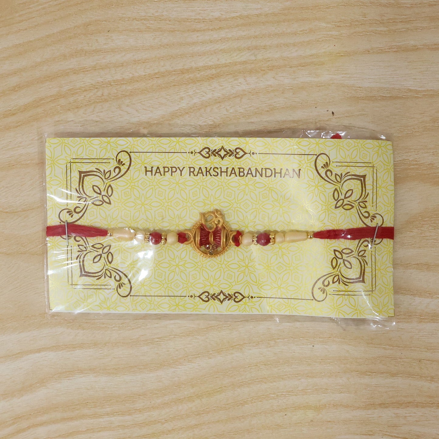 Intricate beadwork and golden Damru design on a festive Raksha Bandhan Rakhi.