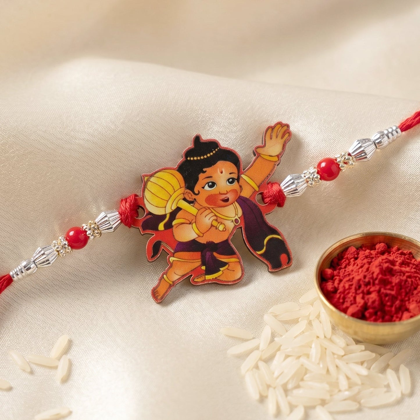 Decorative red beads and Bal Hanuman motif on Rakhi