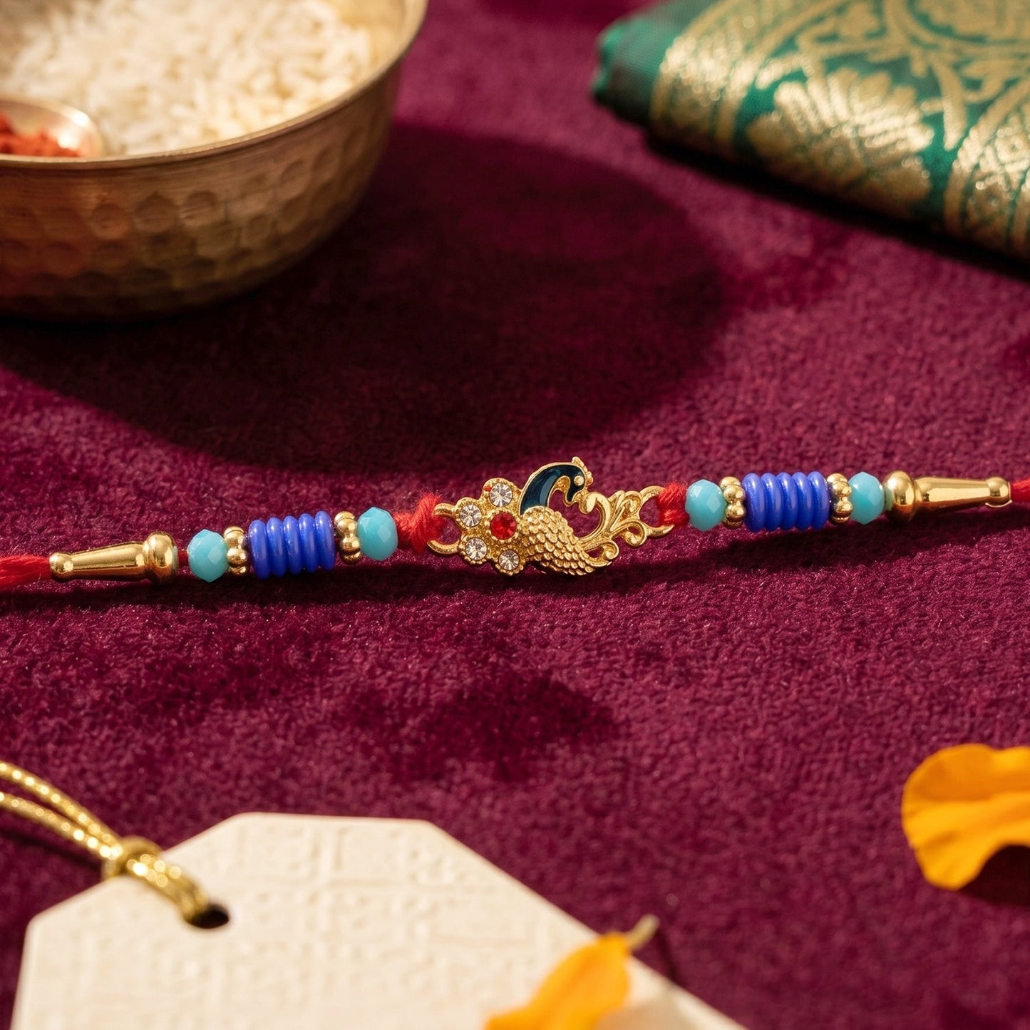 Close-up of peacock centerpiece on Rakhi, highlighting intricate design