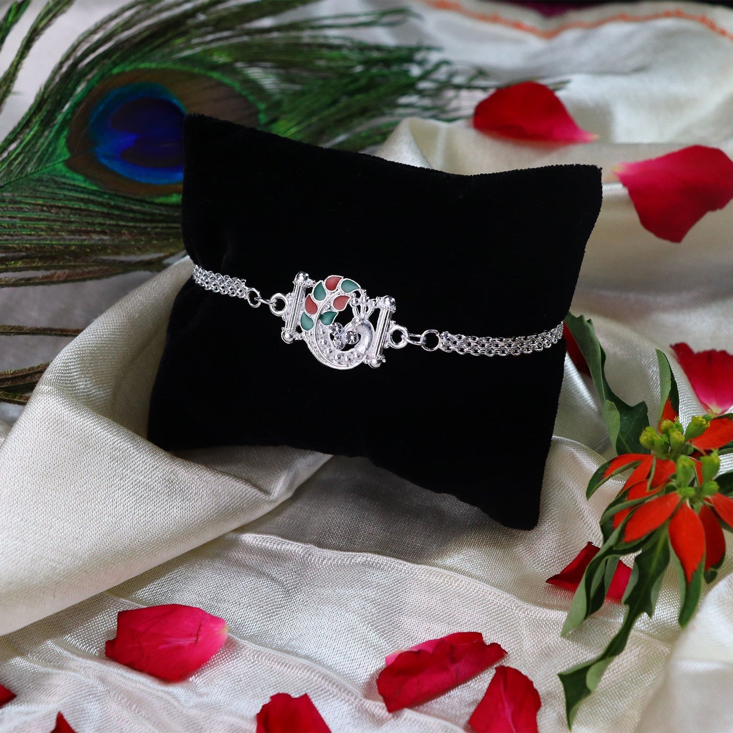Side view of Silver Finish Rakhi showing metallic luster and vibrant enamel
