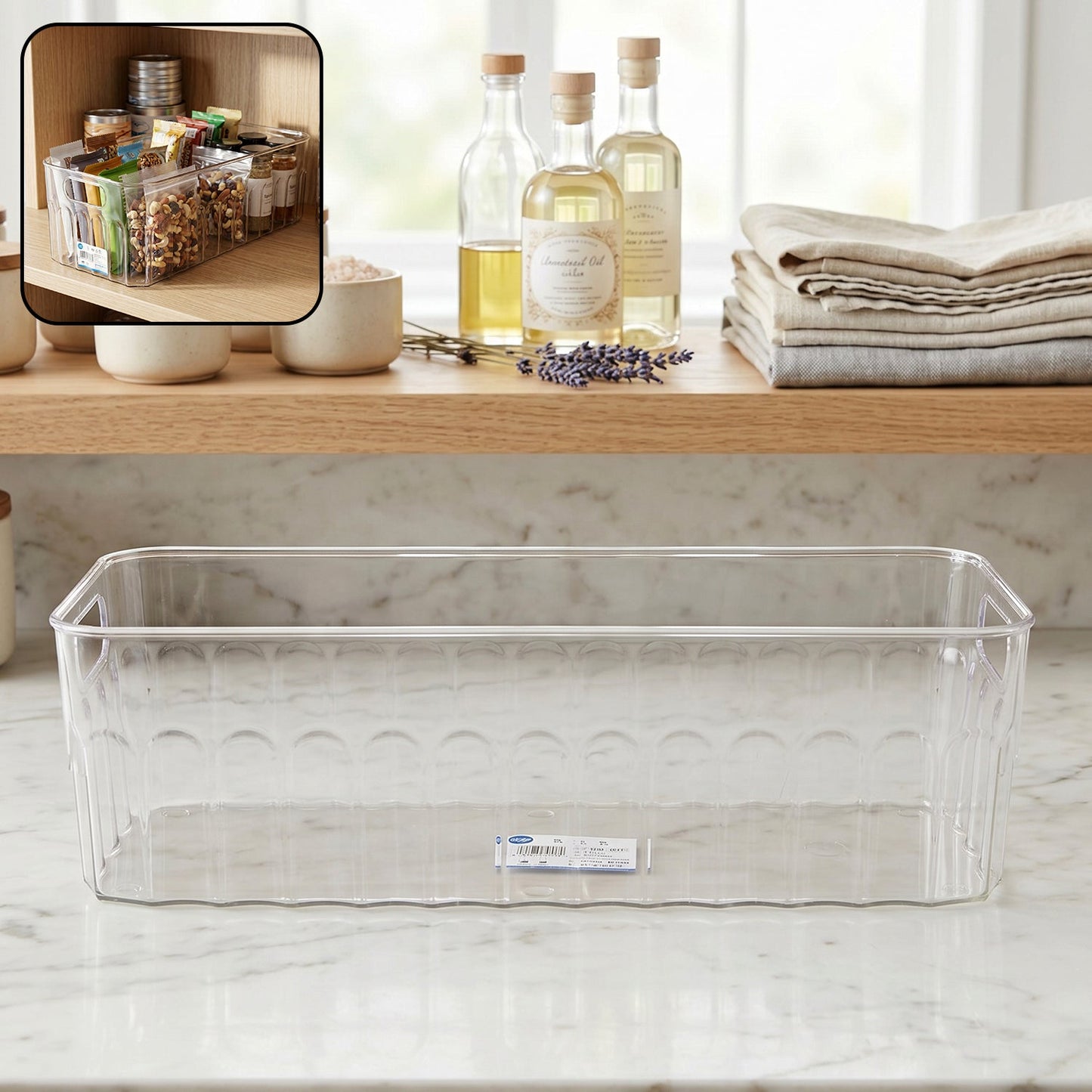 Transparent plastic fridge organizer basket with handles for easy lifting.