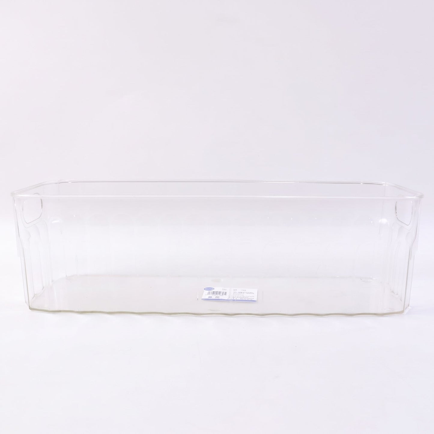 Decorative ribbed sides on a transparent storage basket for kitchen organization.