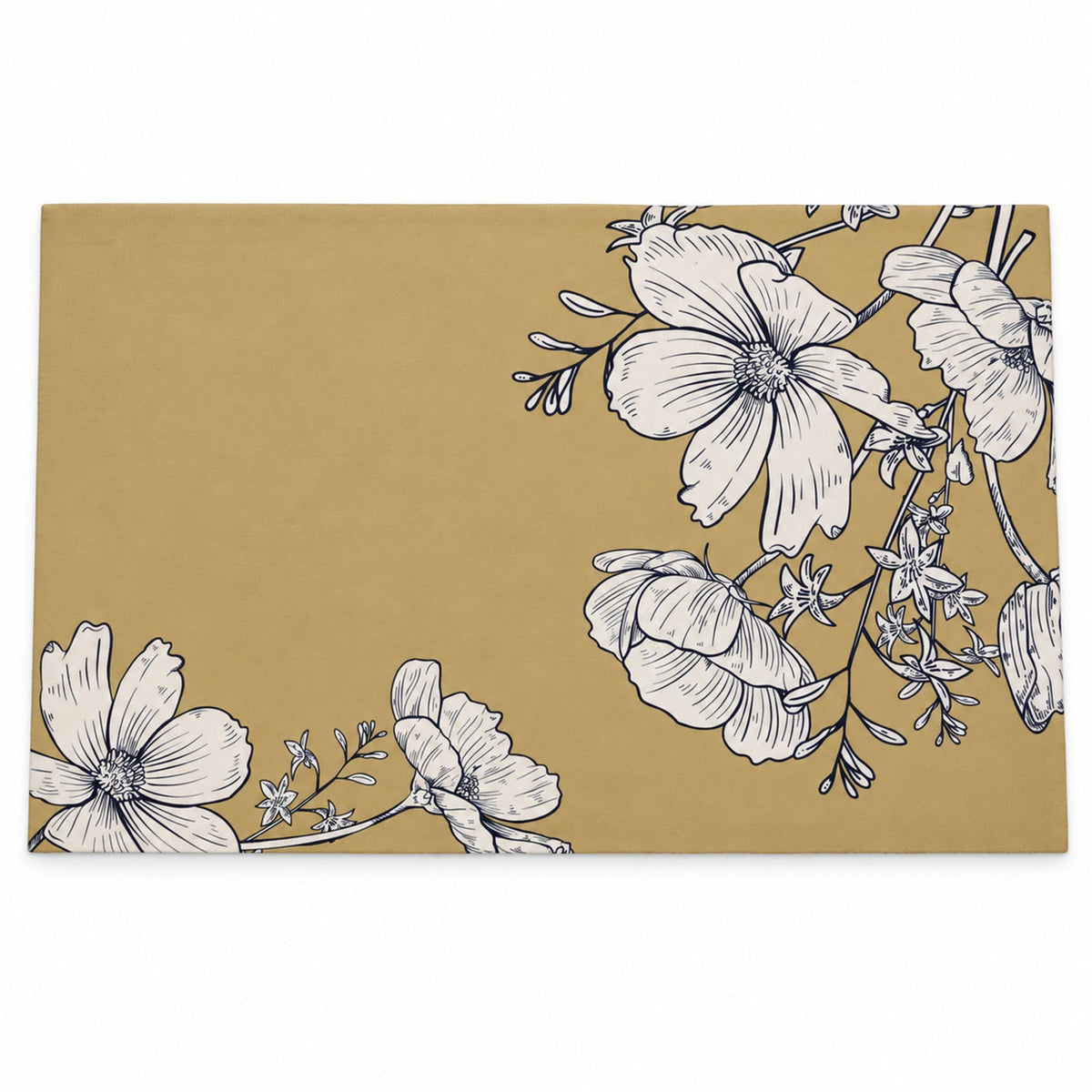 A flat lay of a rectangular mustard yellow mat with white outlined flowers in two corners.
