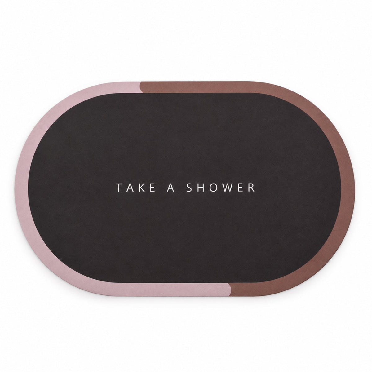 A dark oval bath mat with a pink and brown border, featuring the text "TAKE A SHOWER," is displayed on a white surface.