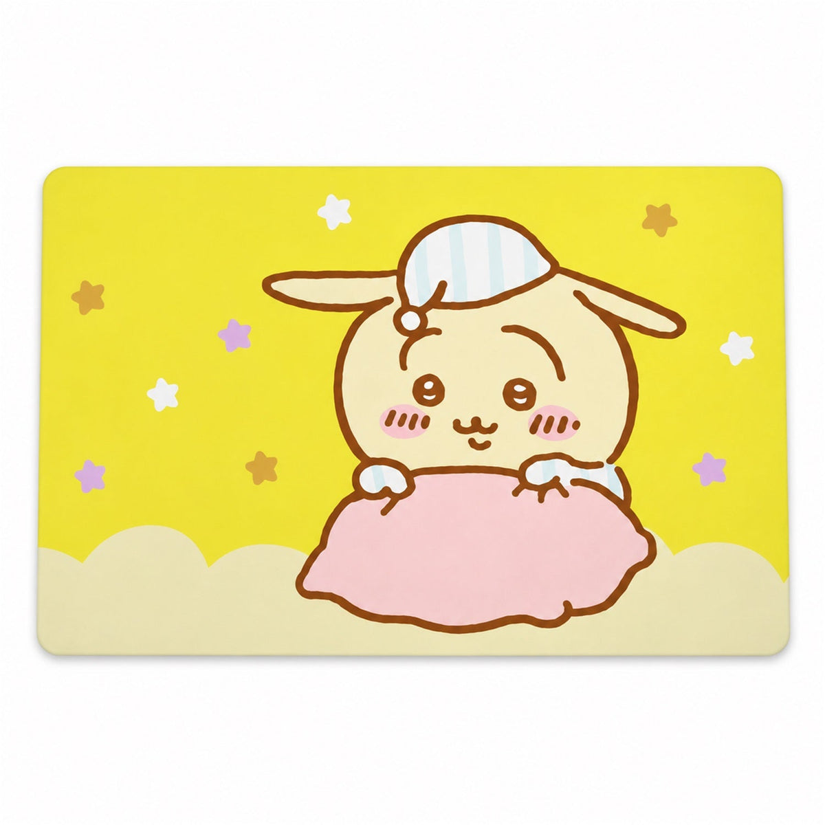 A rectangular yellow bath mat displays a charming cartoon bunny with a nightcap and stars.