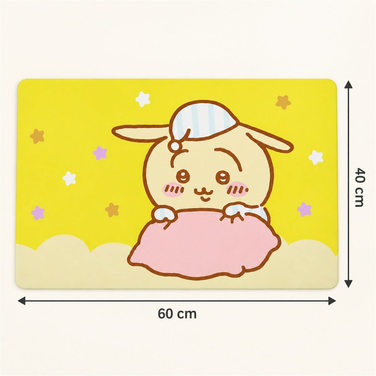 A yellow bath mat with a cartoon bunny design shows its dimensions: 60 cm wide and 40 cm tall.