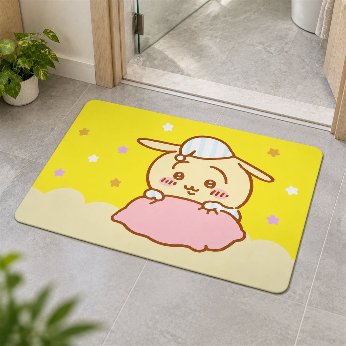 A yellow bath mat with a cartoon bunny design is placed on a gray tiled floor near a doorway.
