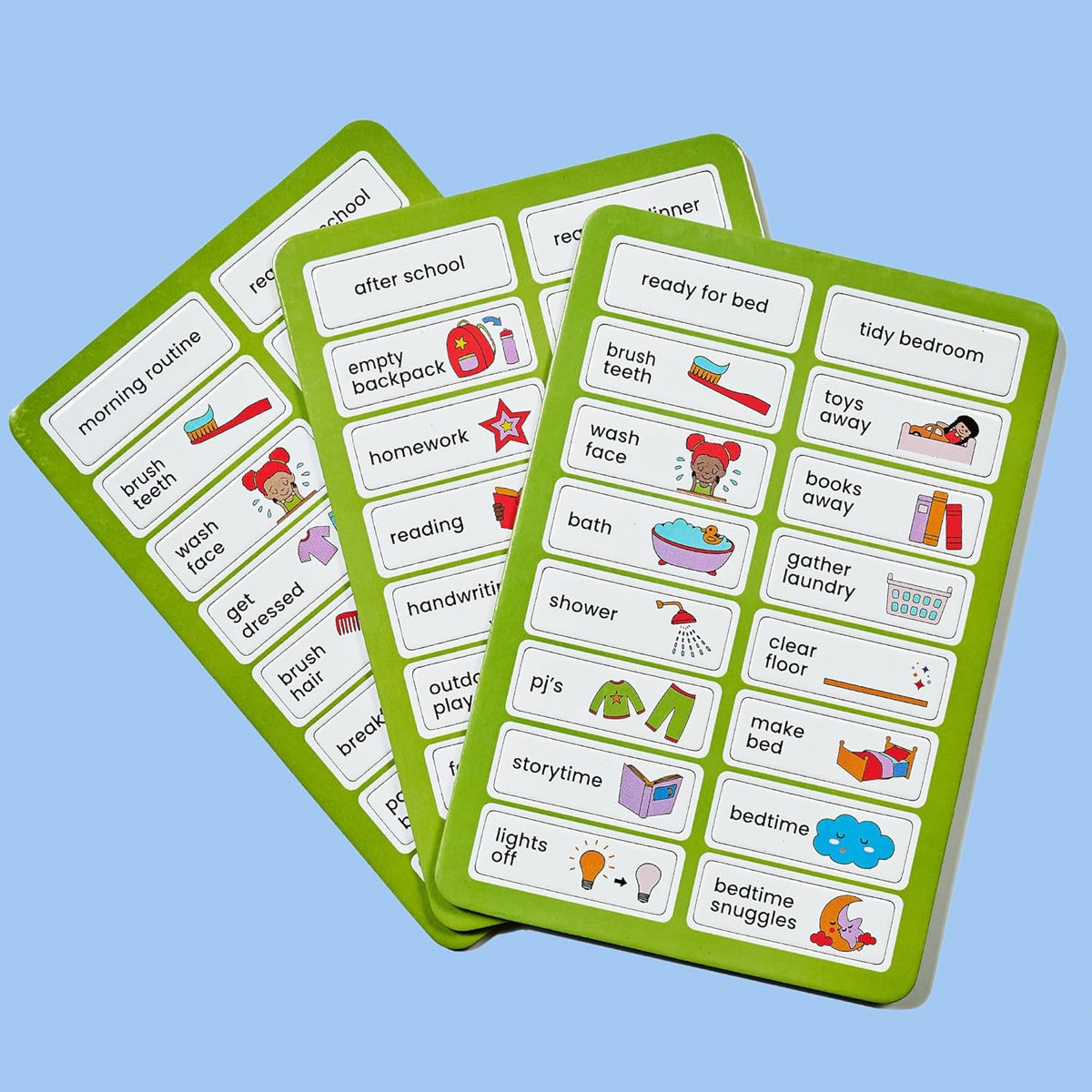 Three green magnetic sheets with various illustrated routine tasks like "brush teeth" and "wash face" on a light blue