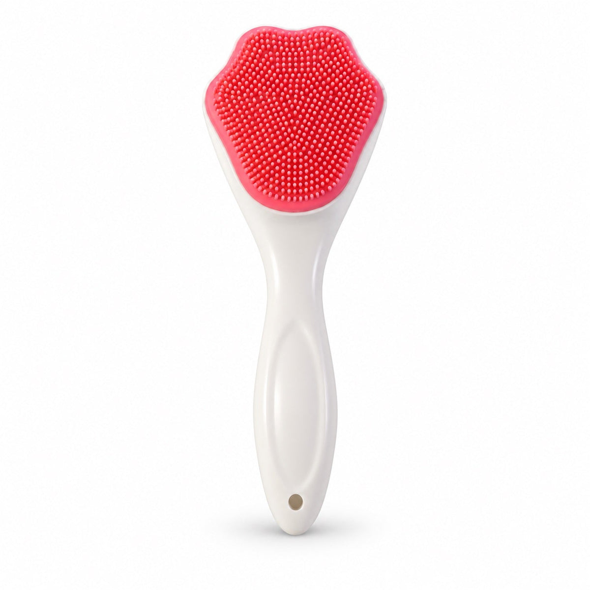 A white-handled brush with a pink, paw-shaped silicone head featuring many small bristles stands upright.