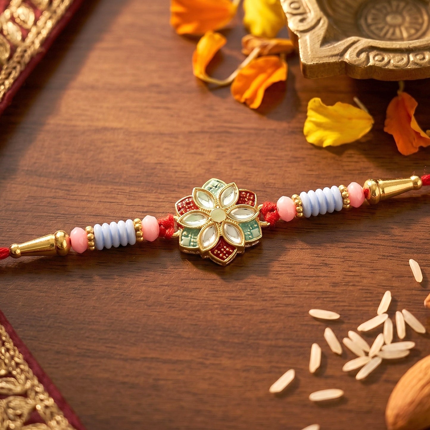 Close-up of floral kundan centerpiece with decorative beads on Rakhi