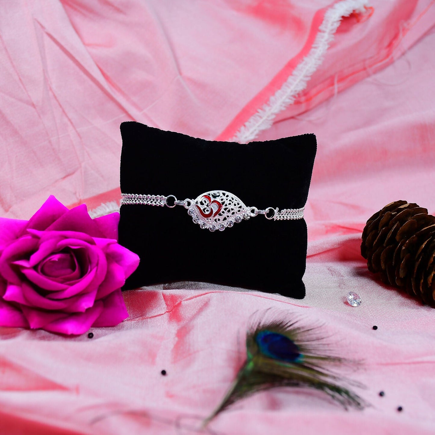 Elegant silver plated dual chain Rakhi with sacred Om motif, styled for Raksha Bandhan