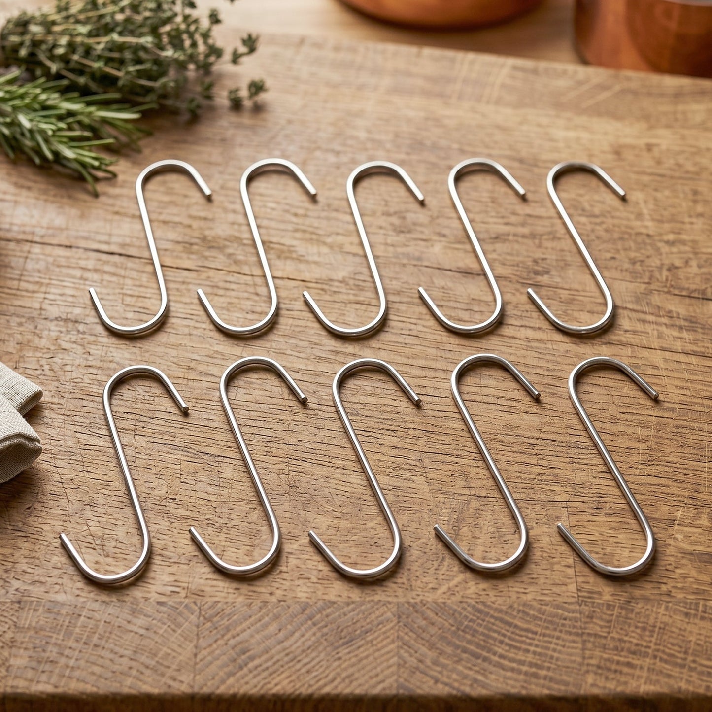 Close-up of a silver S-shaped hook hanging over a rod.