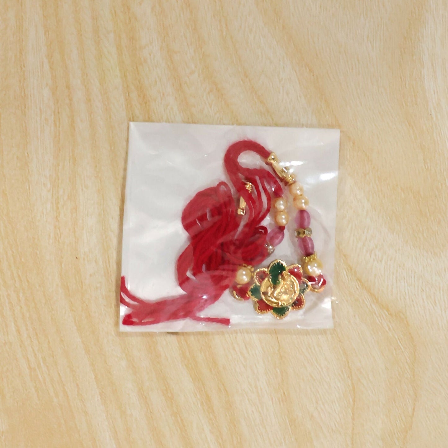 Beautiful floral beads Rakhi with Ganesha motif for brother and sister