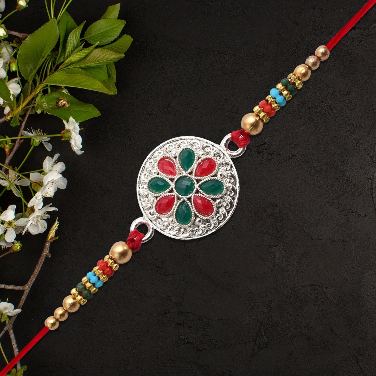 Rakhi with red and green stones on display