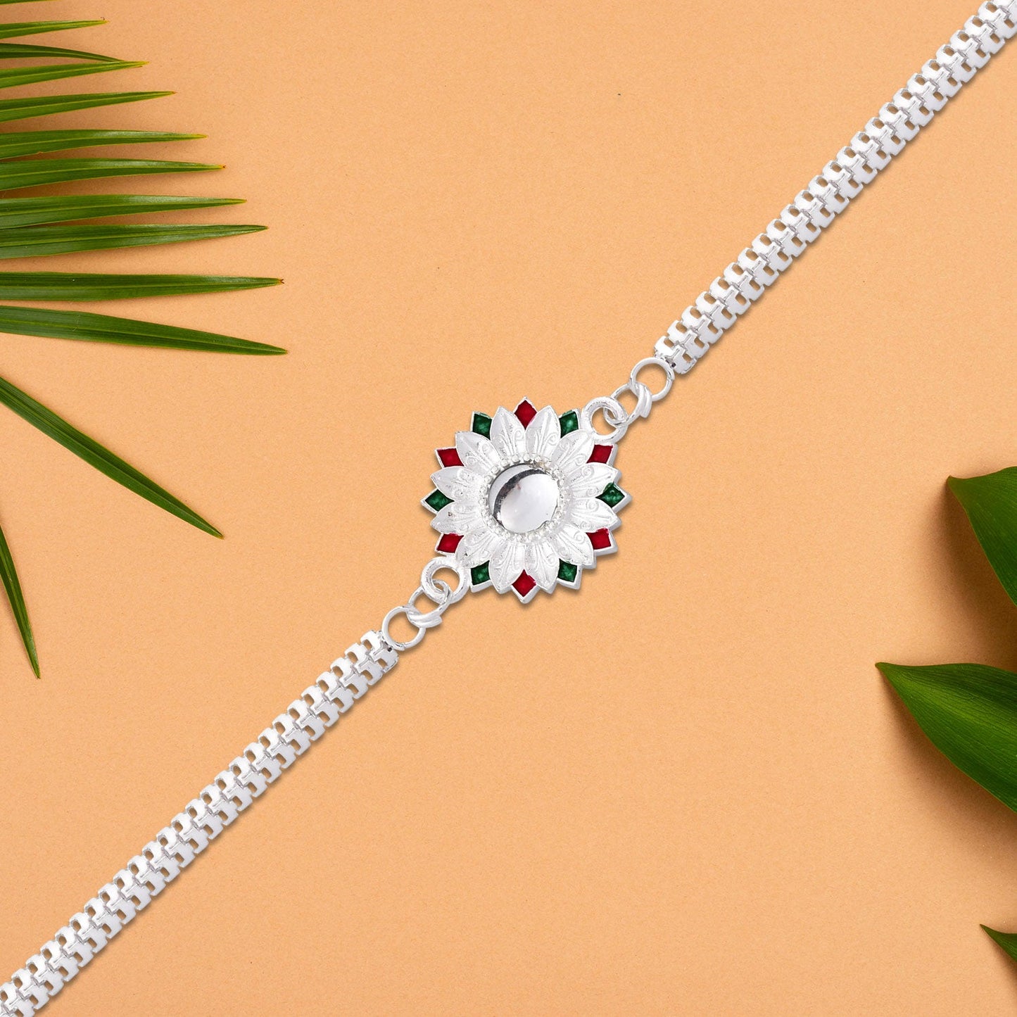 Detailed view of the floral Meenakari work on the Silver Rakhi, showcasing craftsmanship.