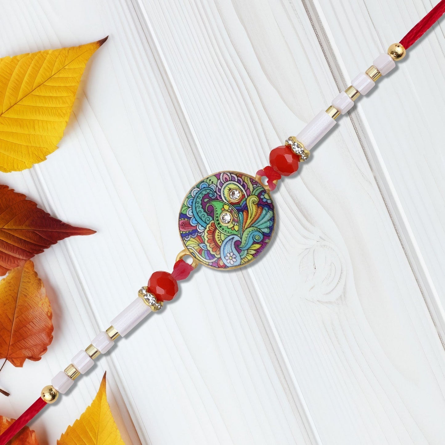 Close-up of Paisley Swirl Rakhi showing fine handcrafted thread work and paisley swirl pattern