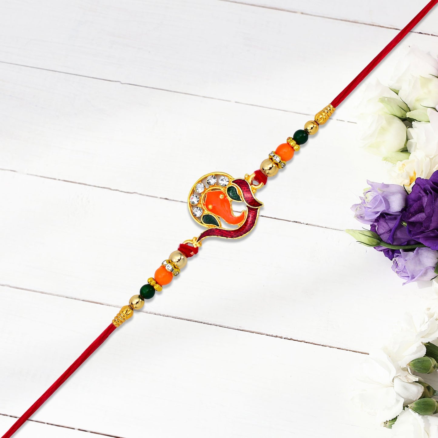 Golden Ganesha Rakhi displaying stone embellishments and vibrant beads