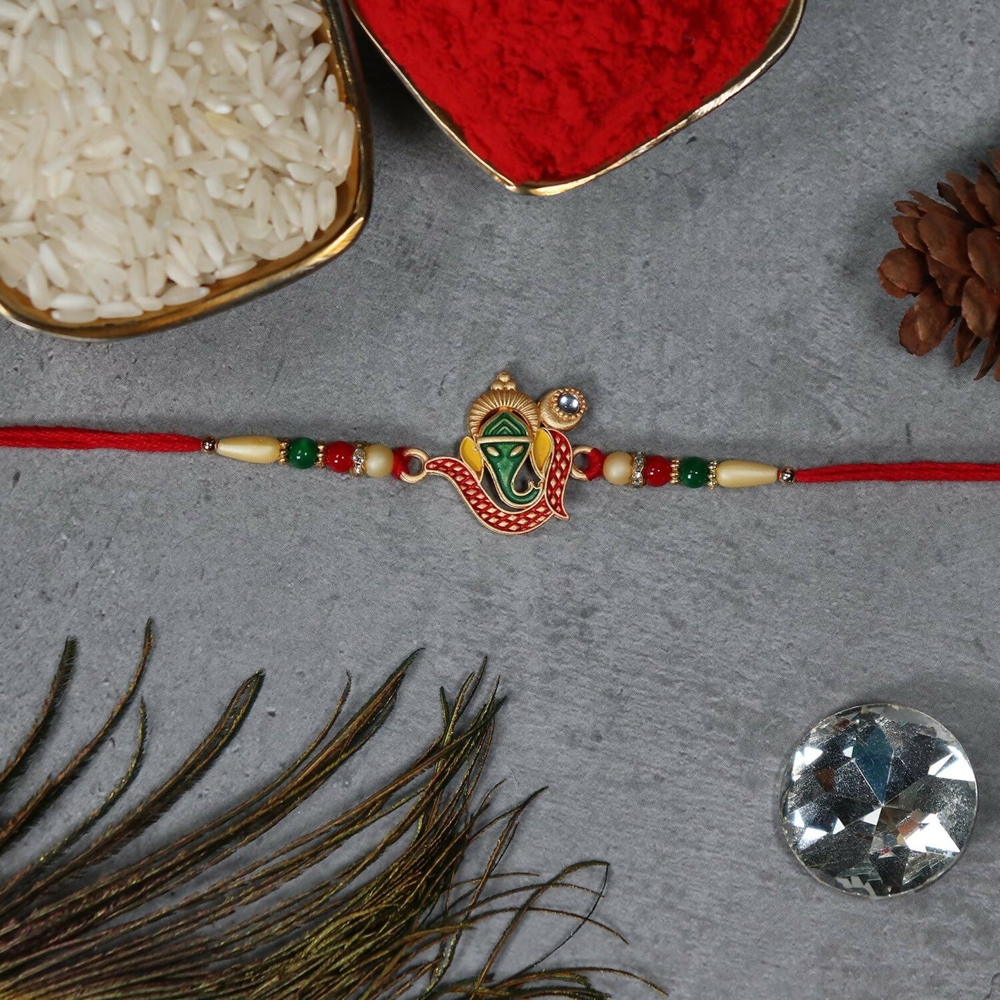 Festive rakhi featuring colorful beads and religious motifs for Raksha Bandhan