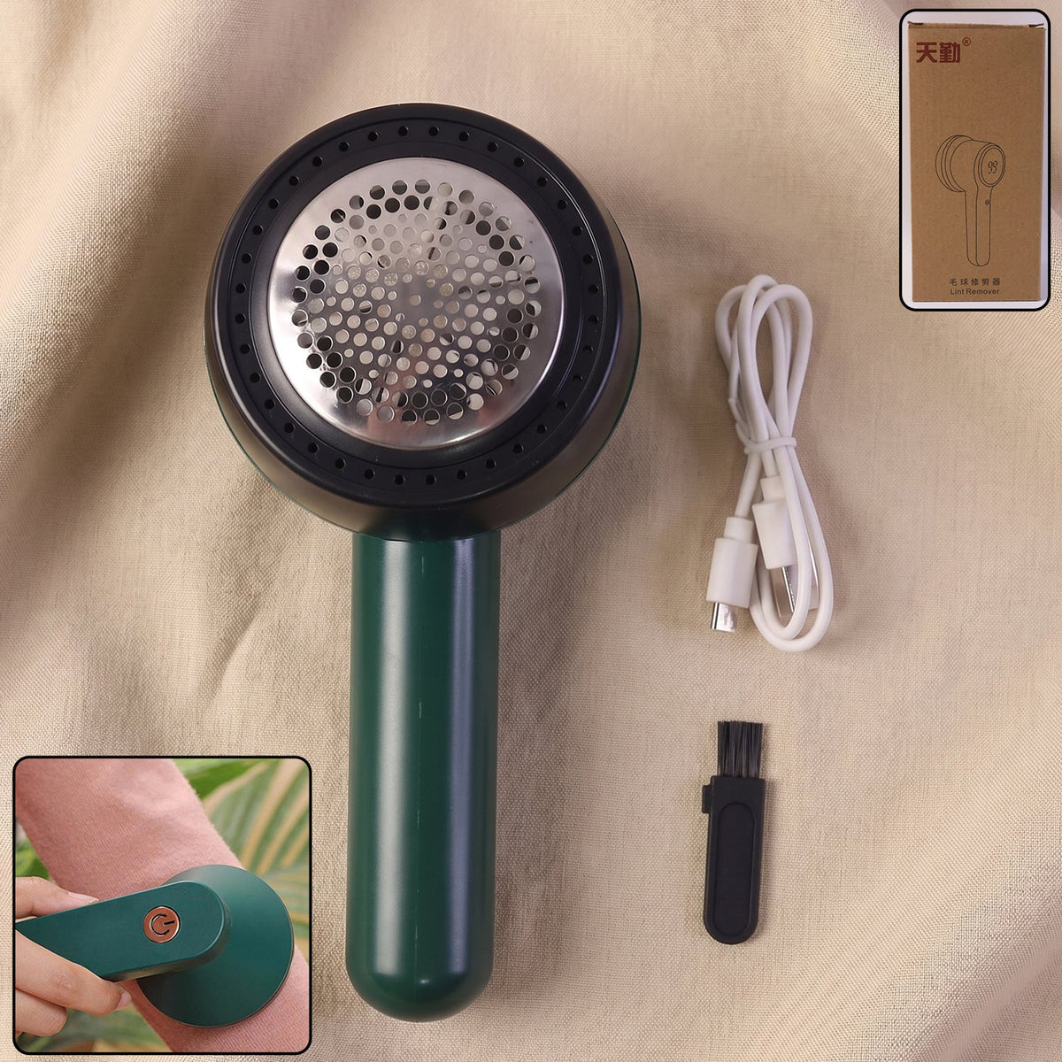 A dark green and black lint remover, white USB-C charging cable, and small black cleaning brush are displayed 