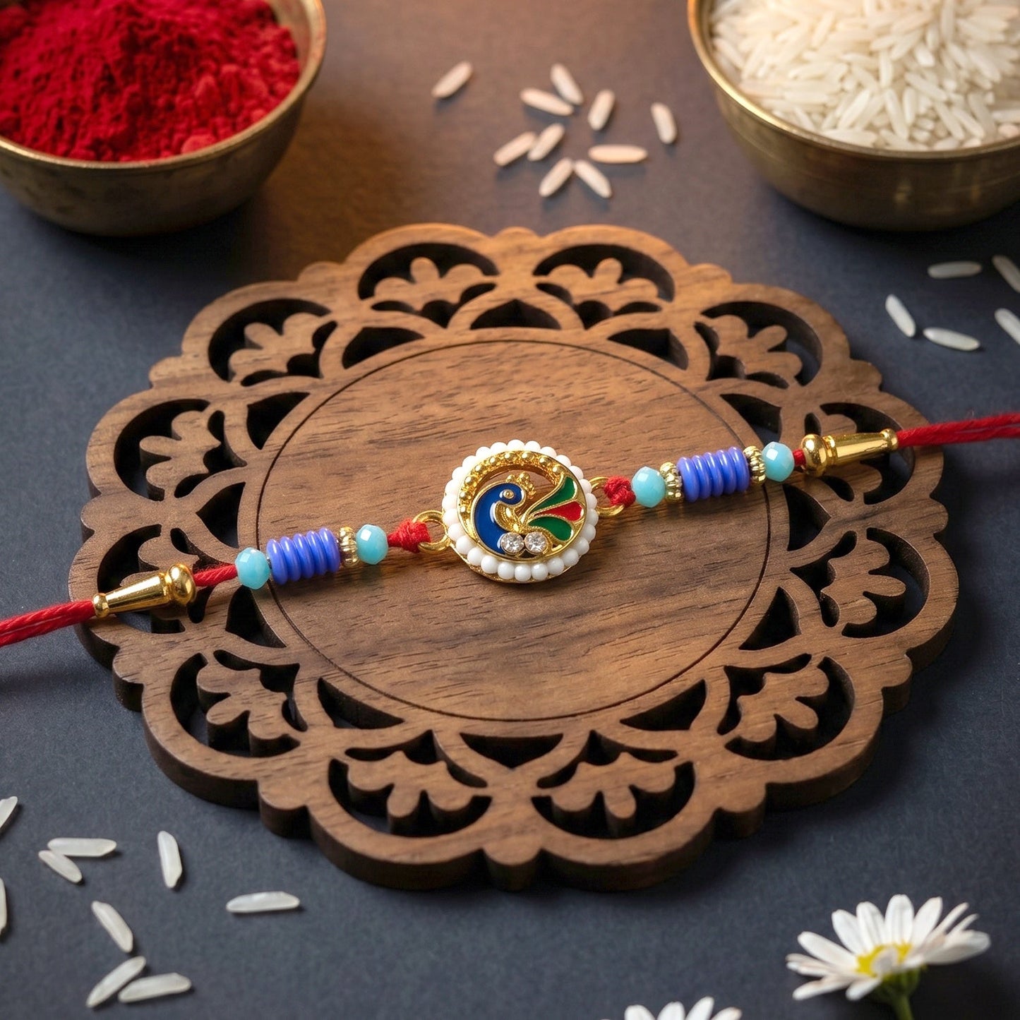Detailed close-up of peacock pearl rakhi with embellishments