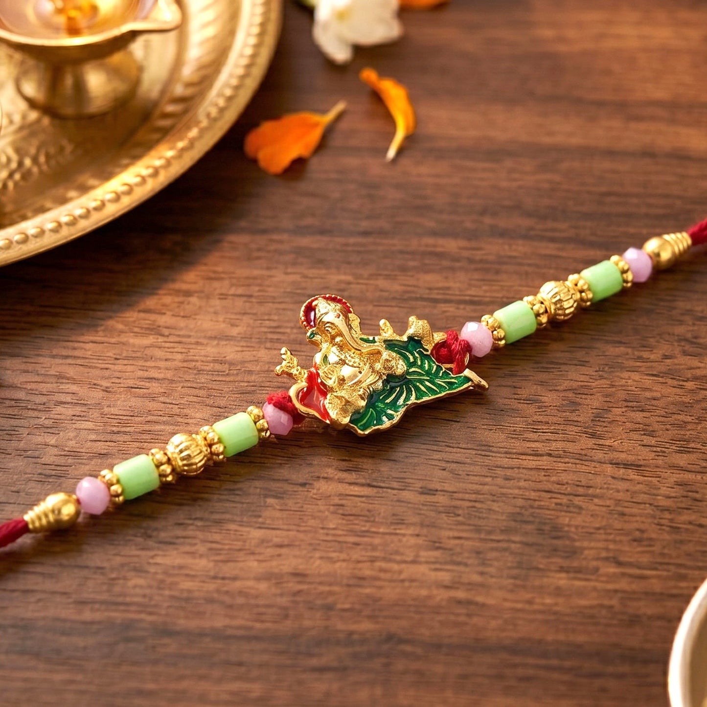 Soft thread and elegant centerpiece of Lord Ganesha Rakhi