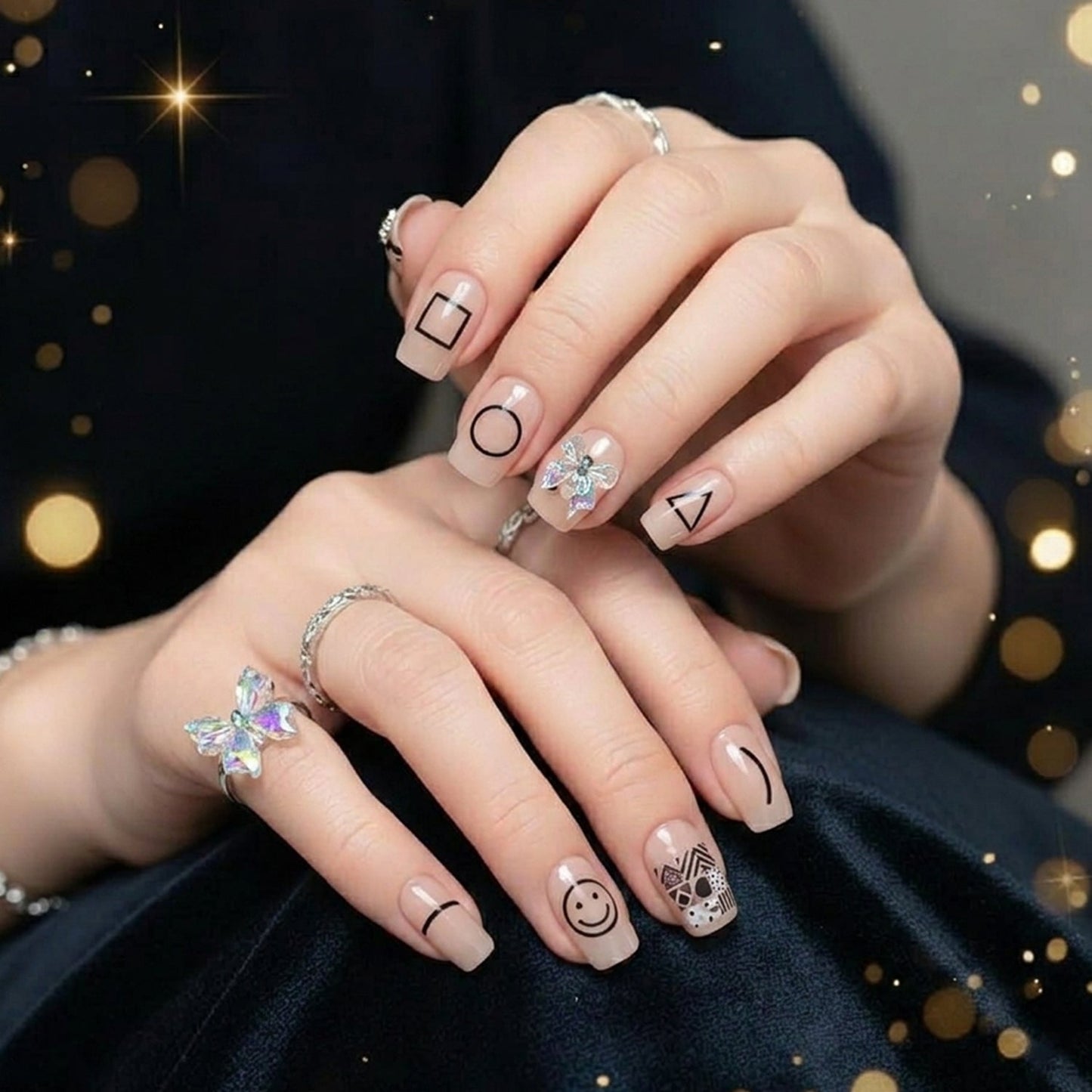 Close-up of glossy false nails with a stylish design, ready for application.