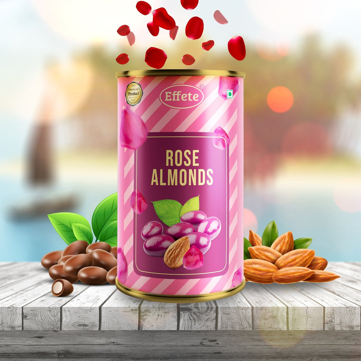 Pink and white striped tin of rose almonds with falling petals, surrounded by loose almonds and chocolate pieces on a wooden