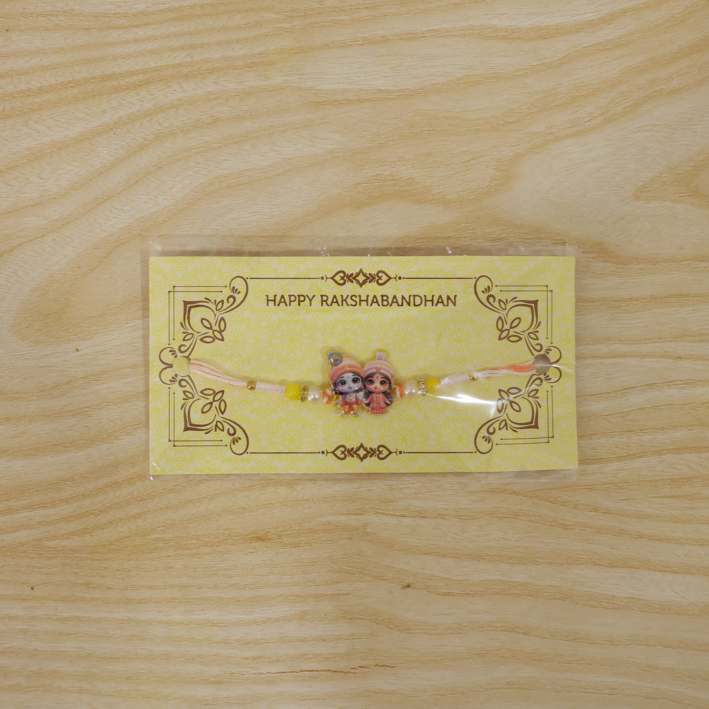 Krishna Radha Rakhi worn on wrist during Raksha Bandhan.