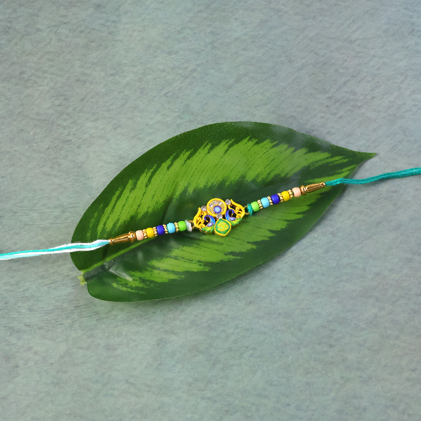 Traditional Rakhi with multicolored beads and yellow thread