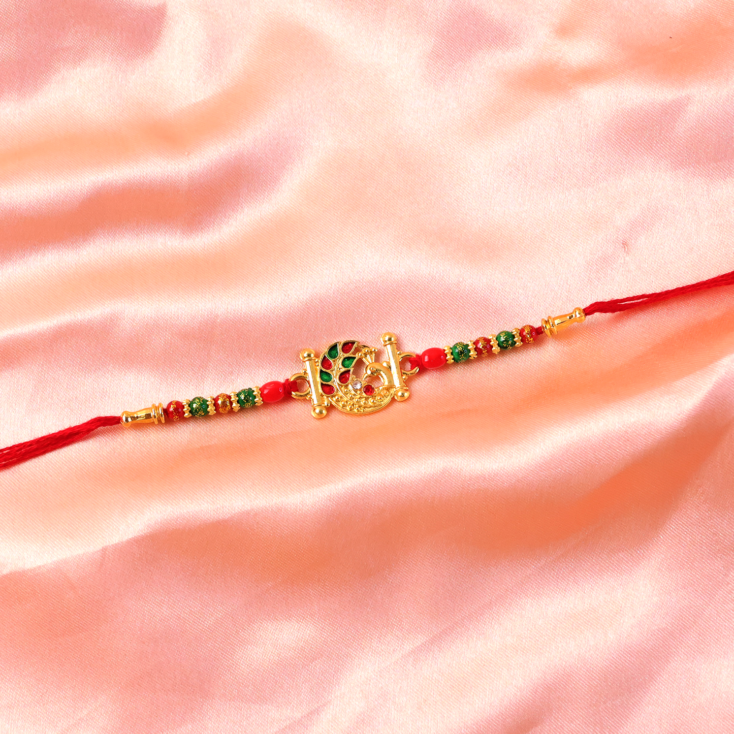 Side profile of the Peacock Rakhi showcasing craftsmanship.