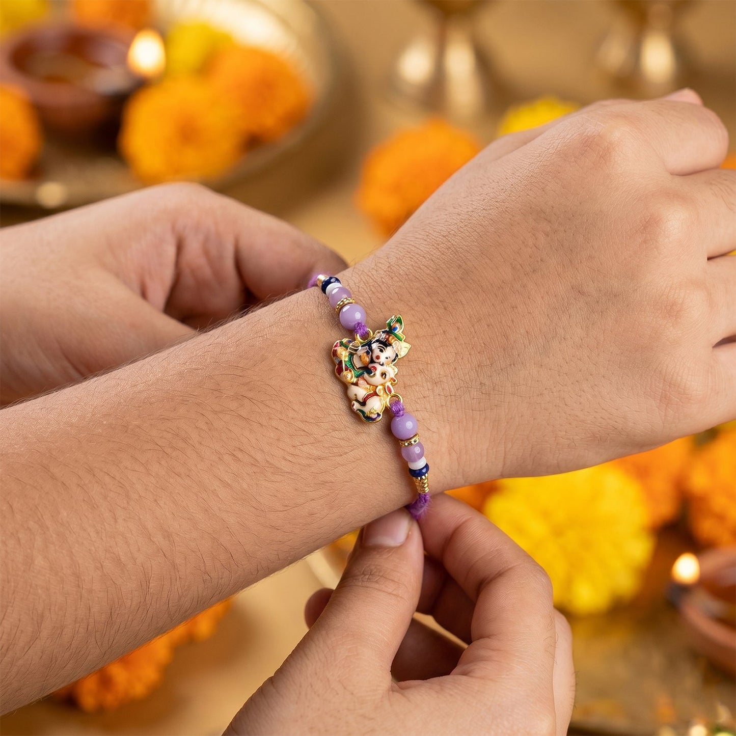 Close-up of Bal Krishna Rakhi showcasing intricate cow design and detailed beads.