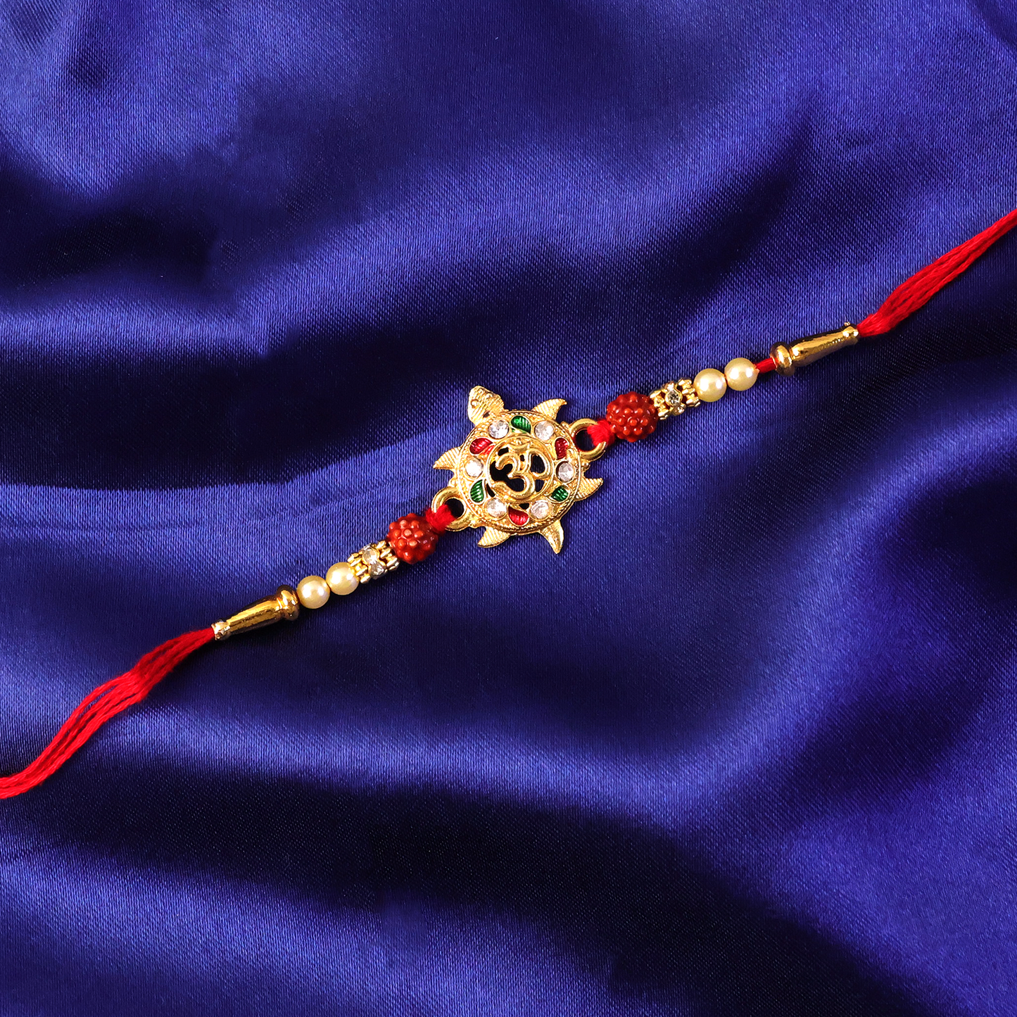 Decorative beads on Om symbol Rakhi for festive look