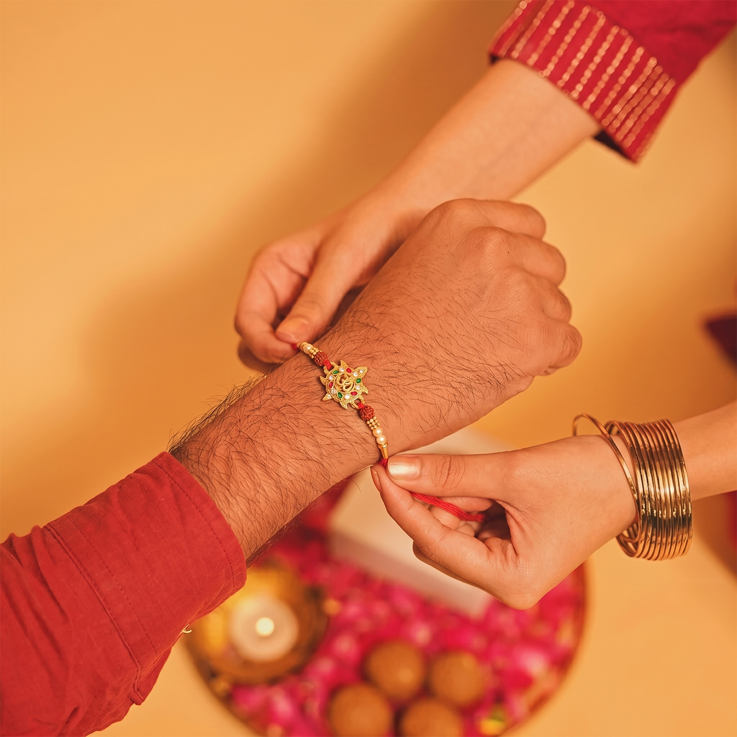 Side view of Om symbol Rakhi with colorful stones