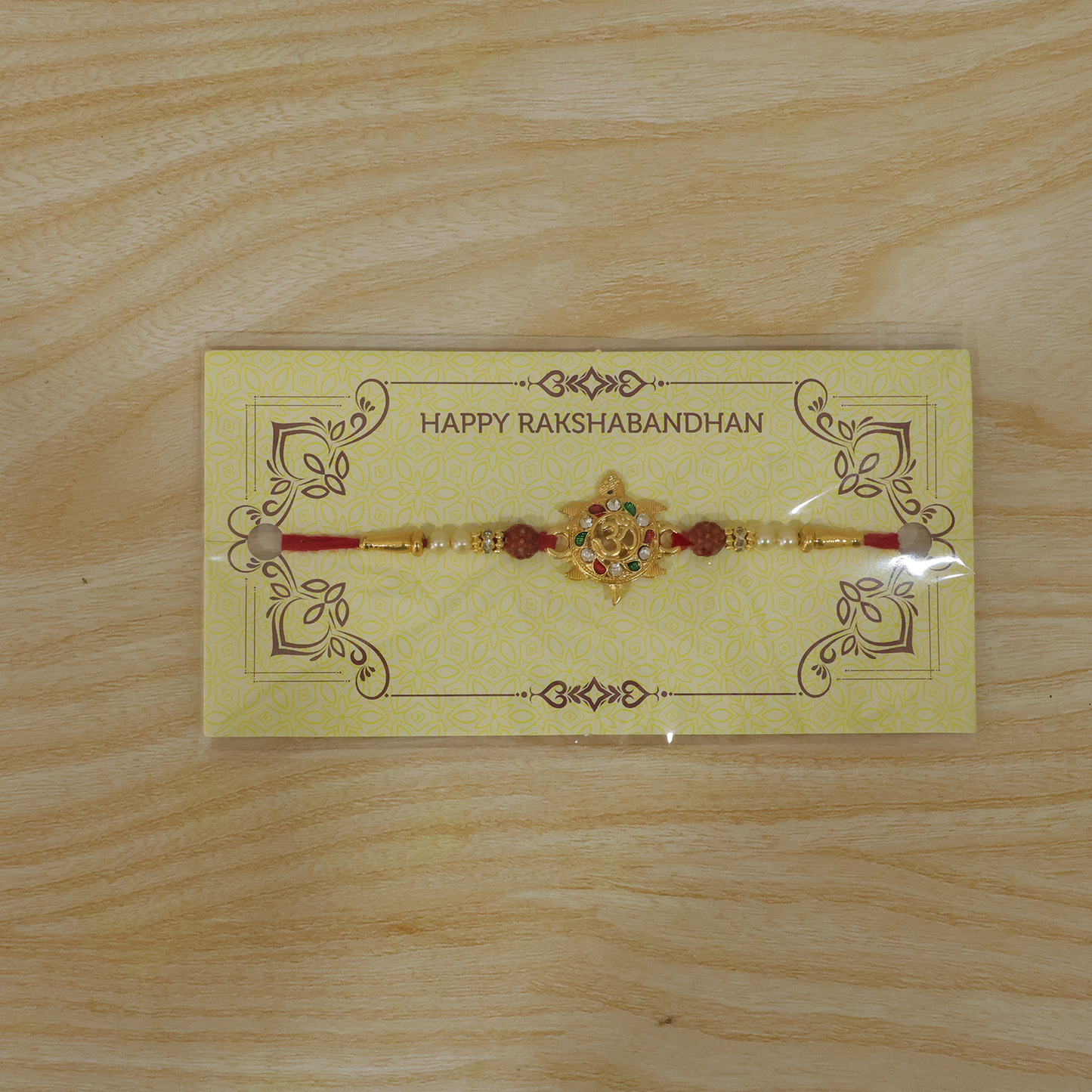 Om symbol Rakhi worn on wrist showing detailed design