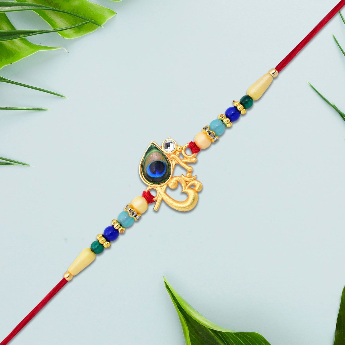 Side view of vibrant Peacock Rakhi highlighting bead and thread craftsmanship.
